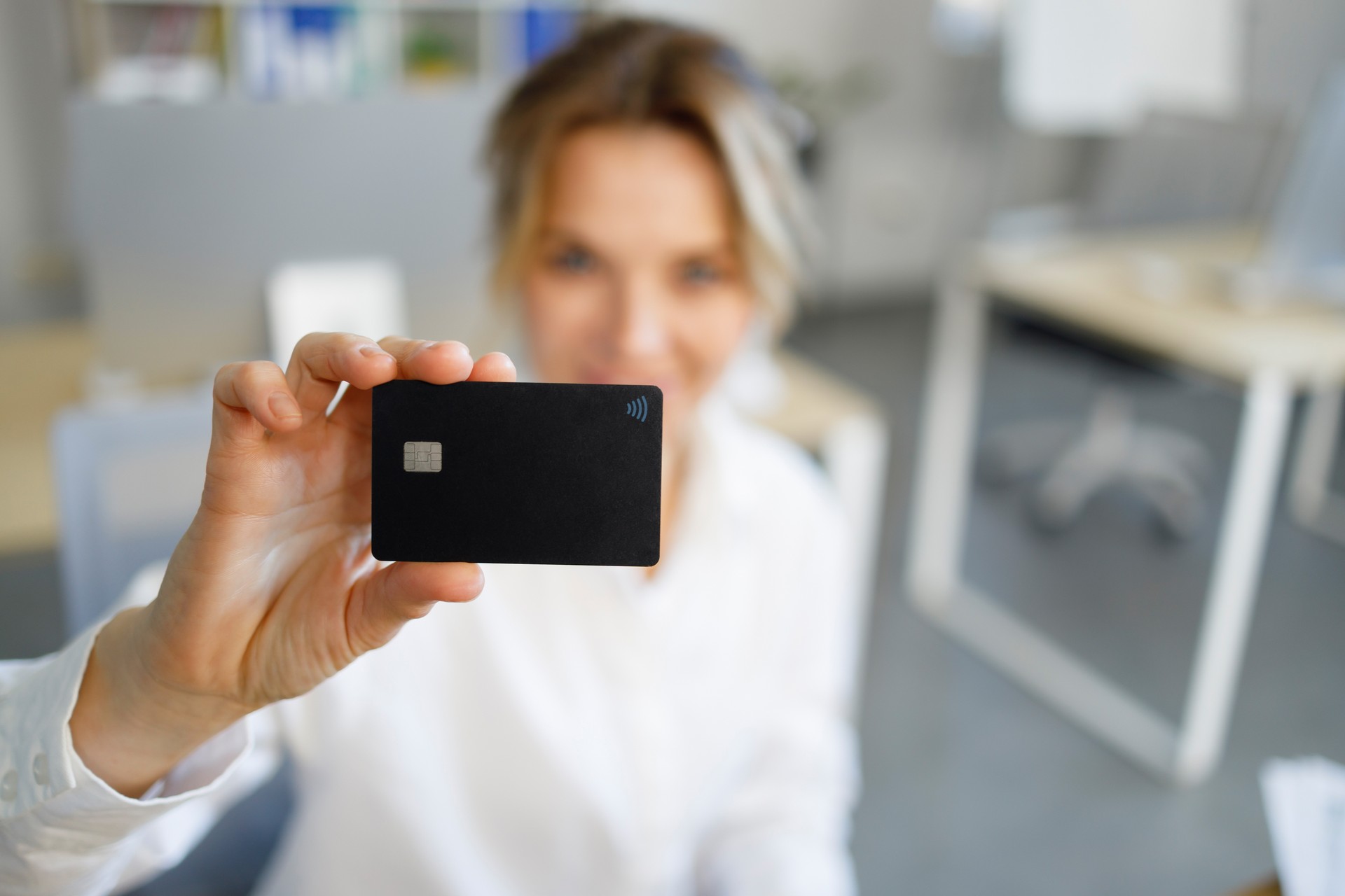 Selective focus of business woman showing credit card